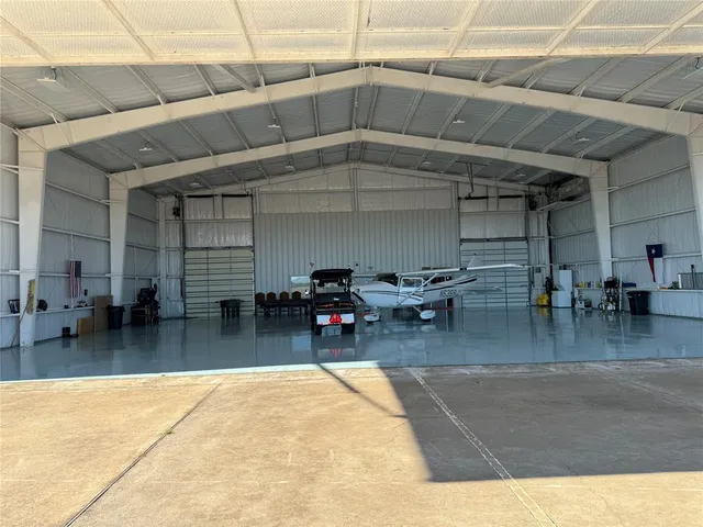 a living room with furniture and a pool table