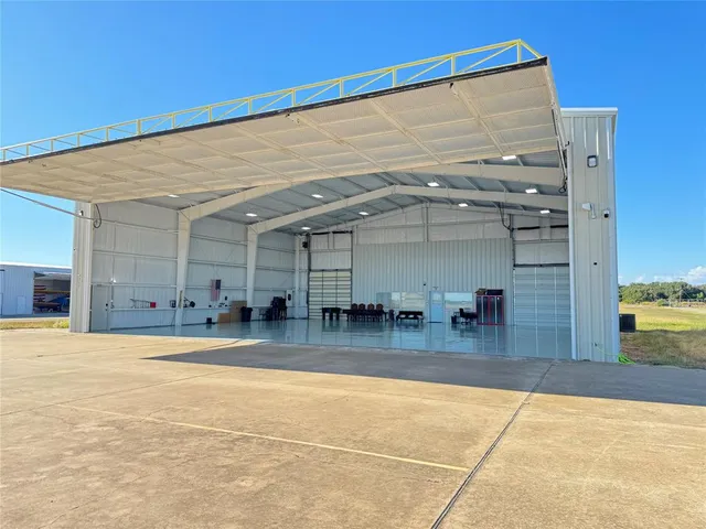 a view of livingroom with dining room and couches with wooden floor