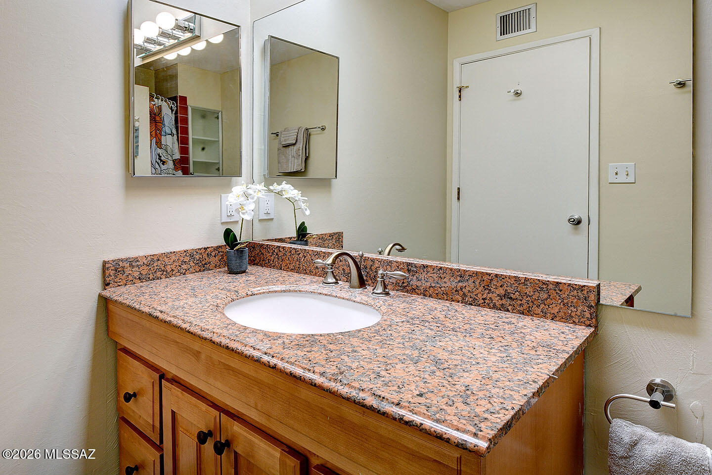 719 West Las Lomitas Road Tucson, AZ 85704 - Photo 32 of 44 a bathroom with a granite countertop sink and a mirror