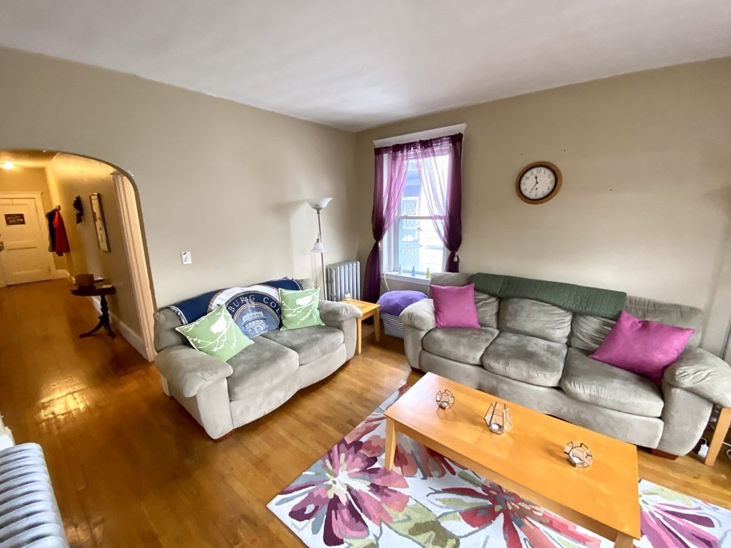 a living room with furniture rug and lamp