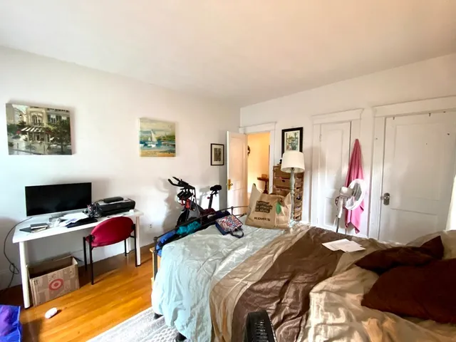 a bed room with a bed a television and a window