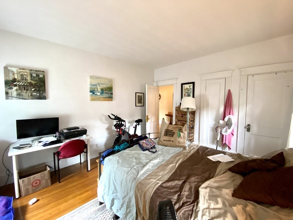 15 Parkman Street, Unit 3B Brookline, MA 02446 - Photo 11 of 15 a bed room with a bed a television and a window