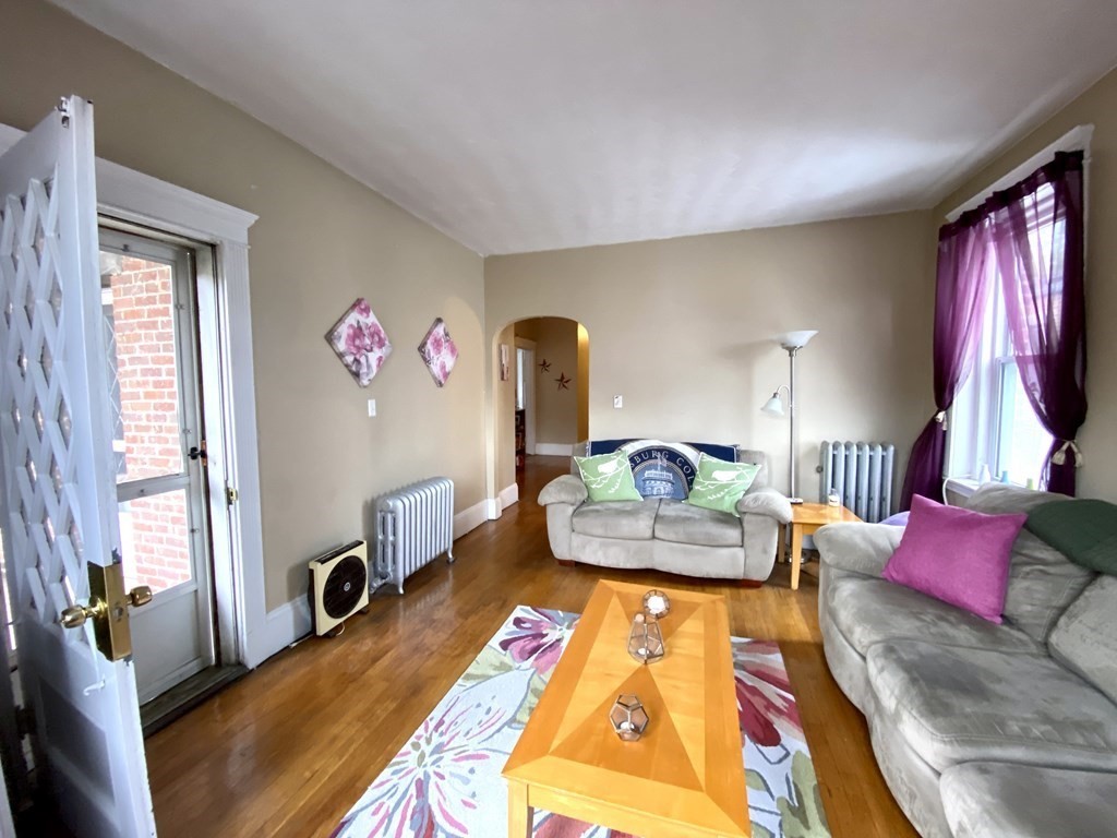 15 Parkman Street, Unit 3B Brookline, MA 02446 - Photo 14 of 15 a living room with furniture and a large window