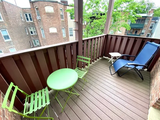 a backyard of a house with table and chairs