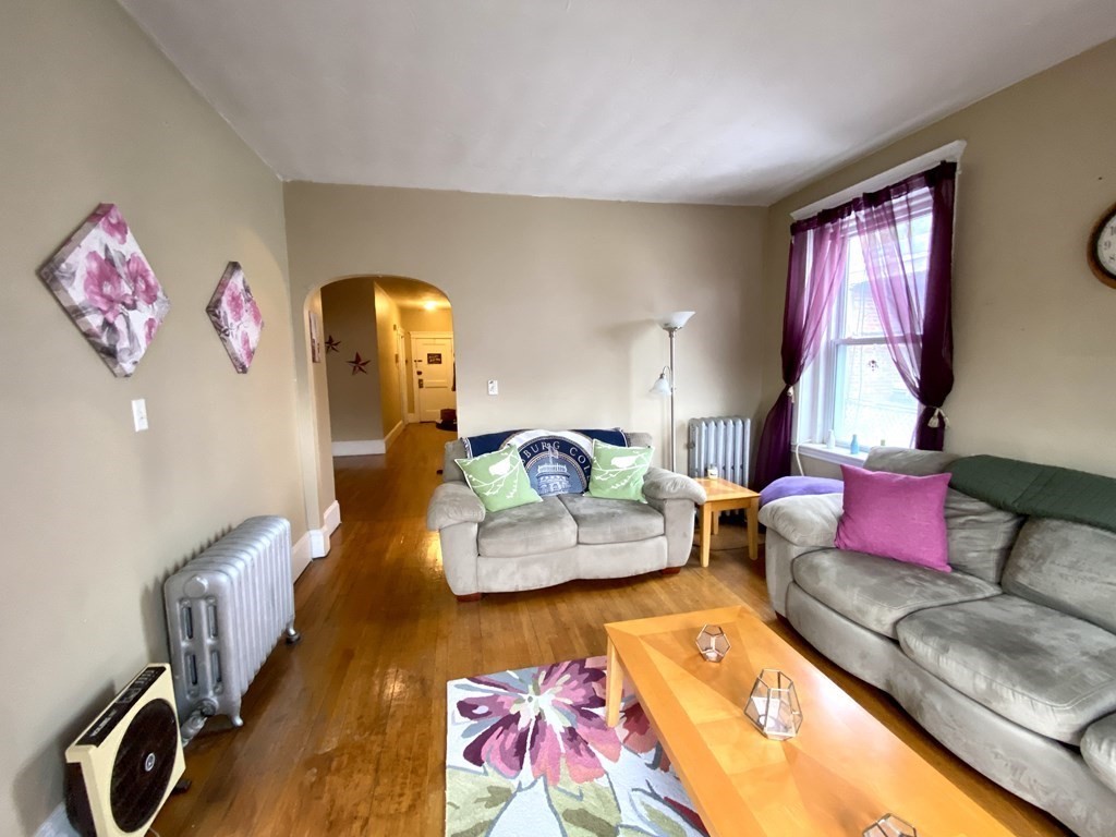 15 Parkman Street, Unit 3B Brookline, MA 02446 - Photo 2 of 15 a living room with furniture gym equipment and a window