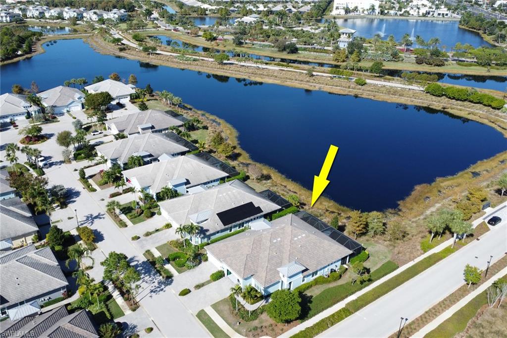 6809 Bequia Way Naples, FL 34113 - Photo 37 of 49 Aerial view of property and surrounding area featuring a large body of water and nearby suburban area