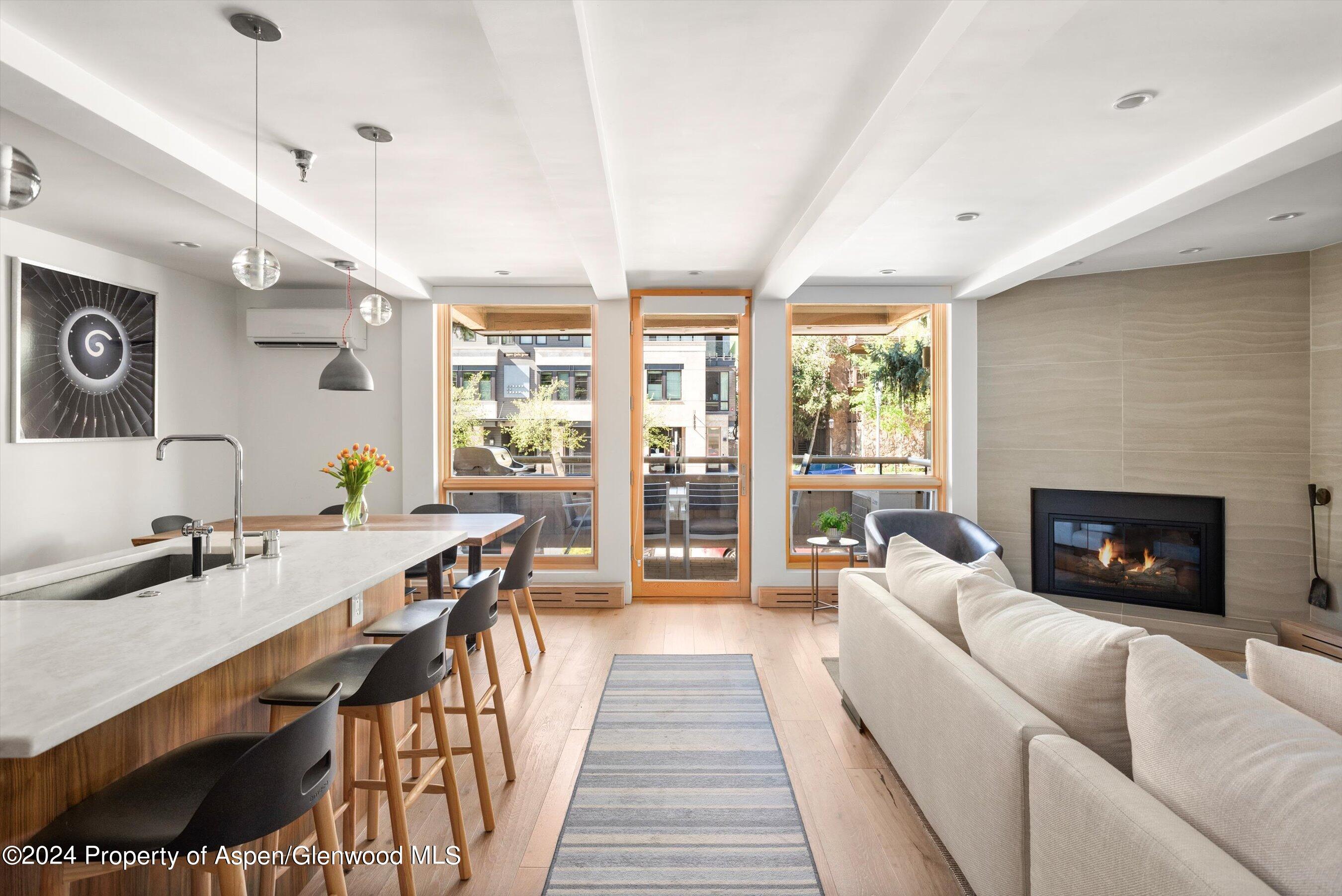 a living room with furniture wooden floor and a fireplace
