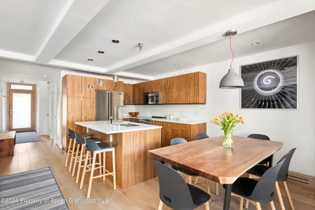 a kitchen with a table and chairs in it