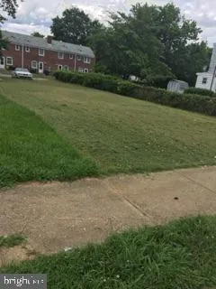a view of a yard with plants and a lake view