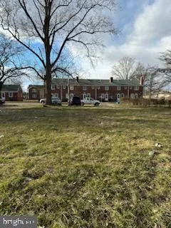 a tall building with trees in front of it
