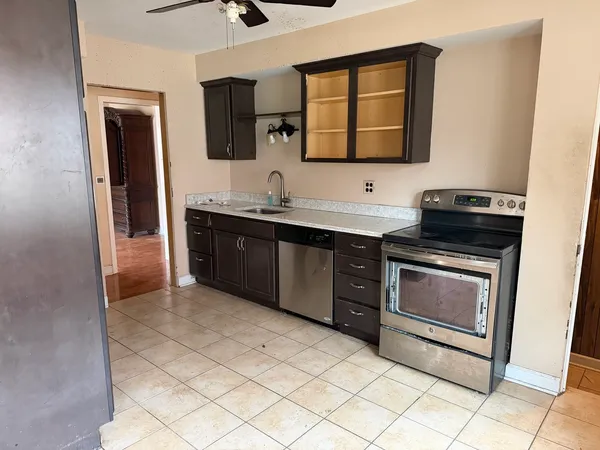 a kitchen with a sink and a stove top oven