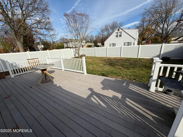 a view of house with backyard and sitting area