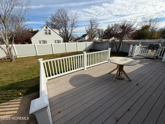a view of balcony with wooden floor and fence