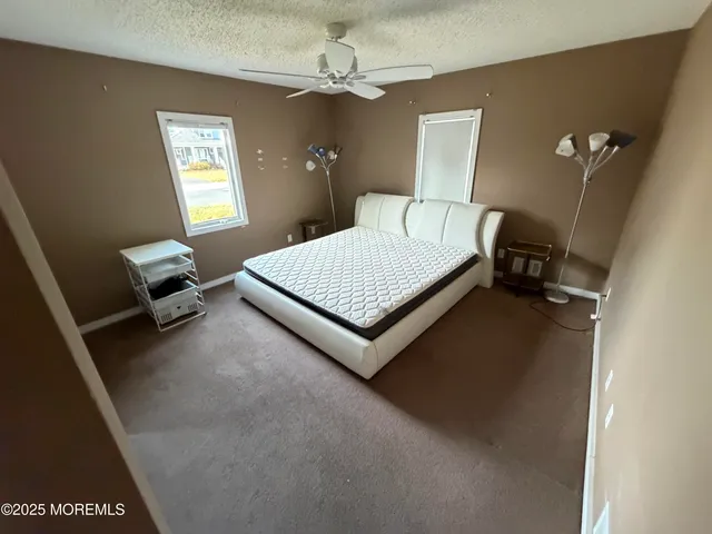 a living room with a bed furniture and a window