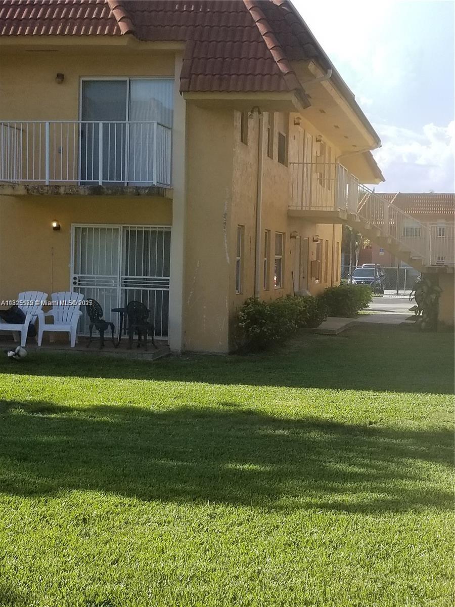 7121 Southwest 129th Avenue, Unit 1 Miami, FL 33183 - Photo 1 of 1 a front view of a house with a garden and lake view
