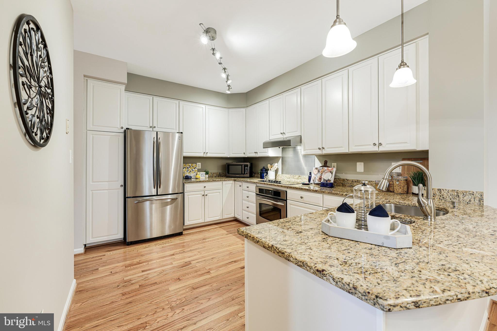 1257 Woodbrook Court Reston, VA 20194 - Photo 22 of 58 a kitchen with a refrigerator a stove a sink and a center island