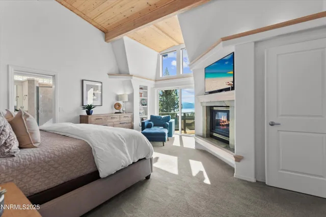 a spacious bedroom with a balcony a bed and a fireplace