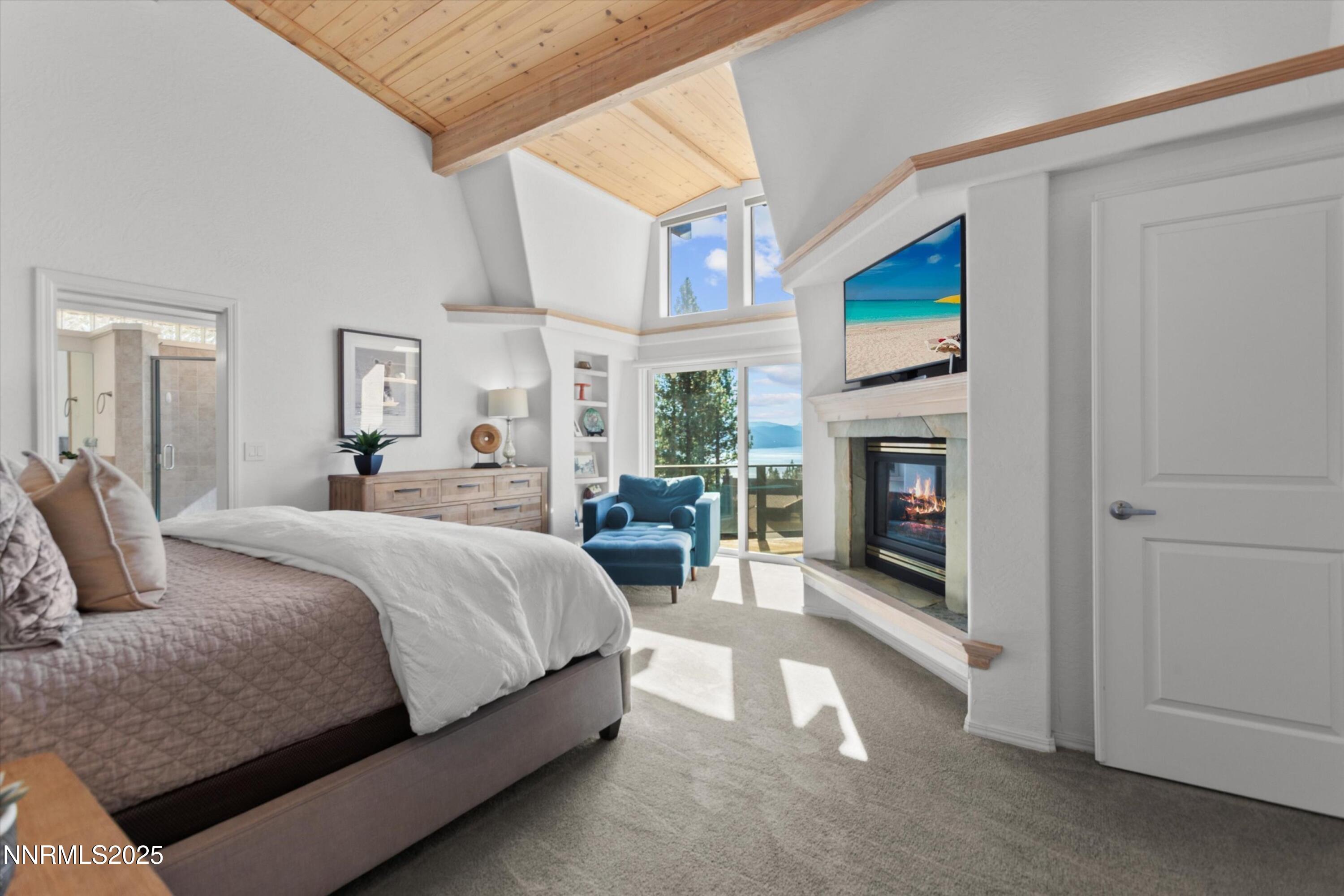 456 Jill Court Incline Village, NV 89451 - Photo 17 of 38 a spacious bedroom with a balcony a bed and a fireplace