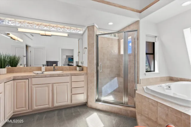 a spacious bathroom with a shower sink and mirror