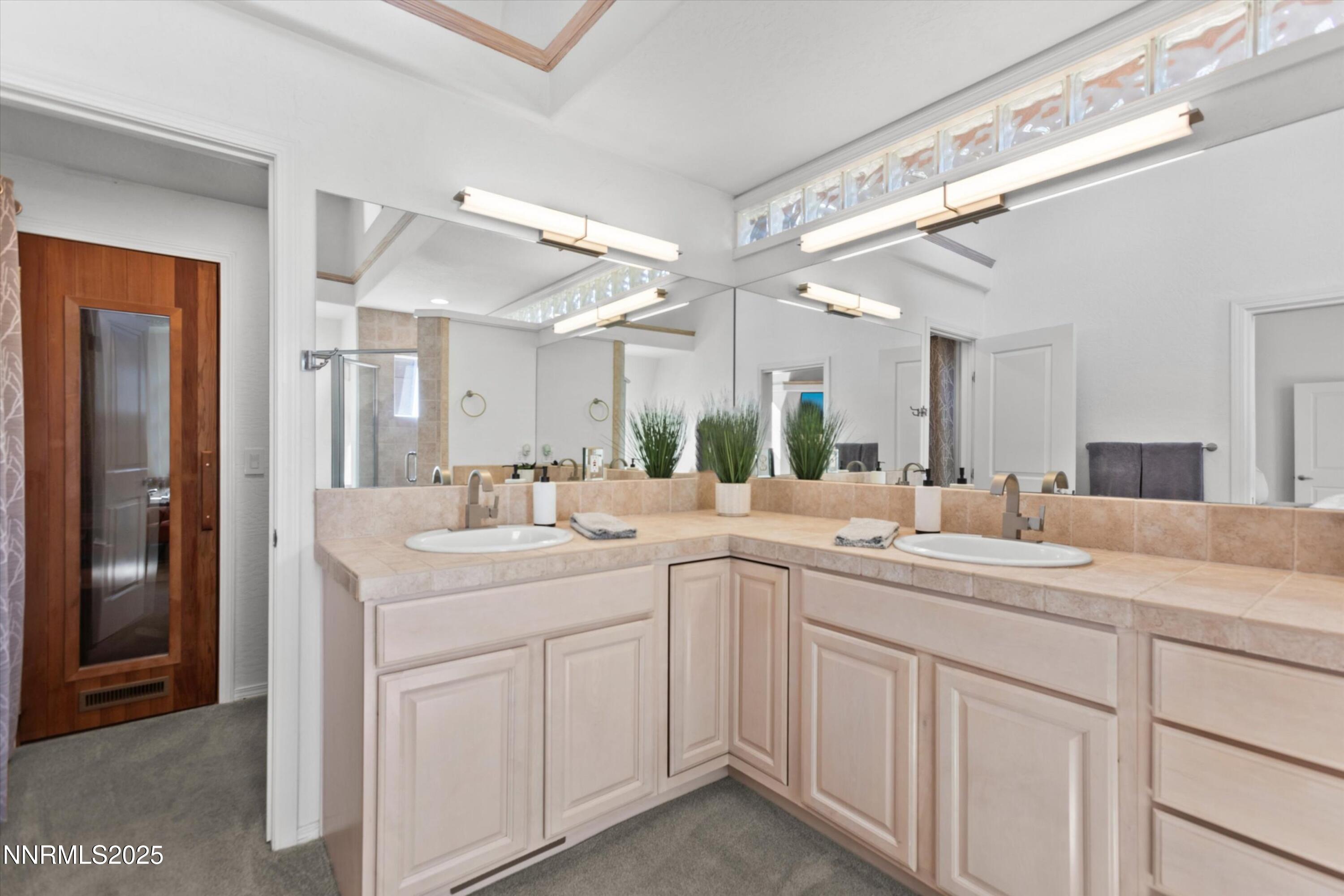 456 Jill Court Incline Village, NV 89451 - Photo 22 of 38 a view of a sink and mirror with cabinets