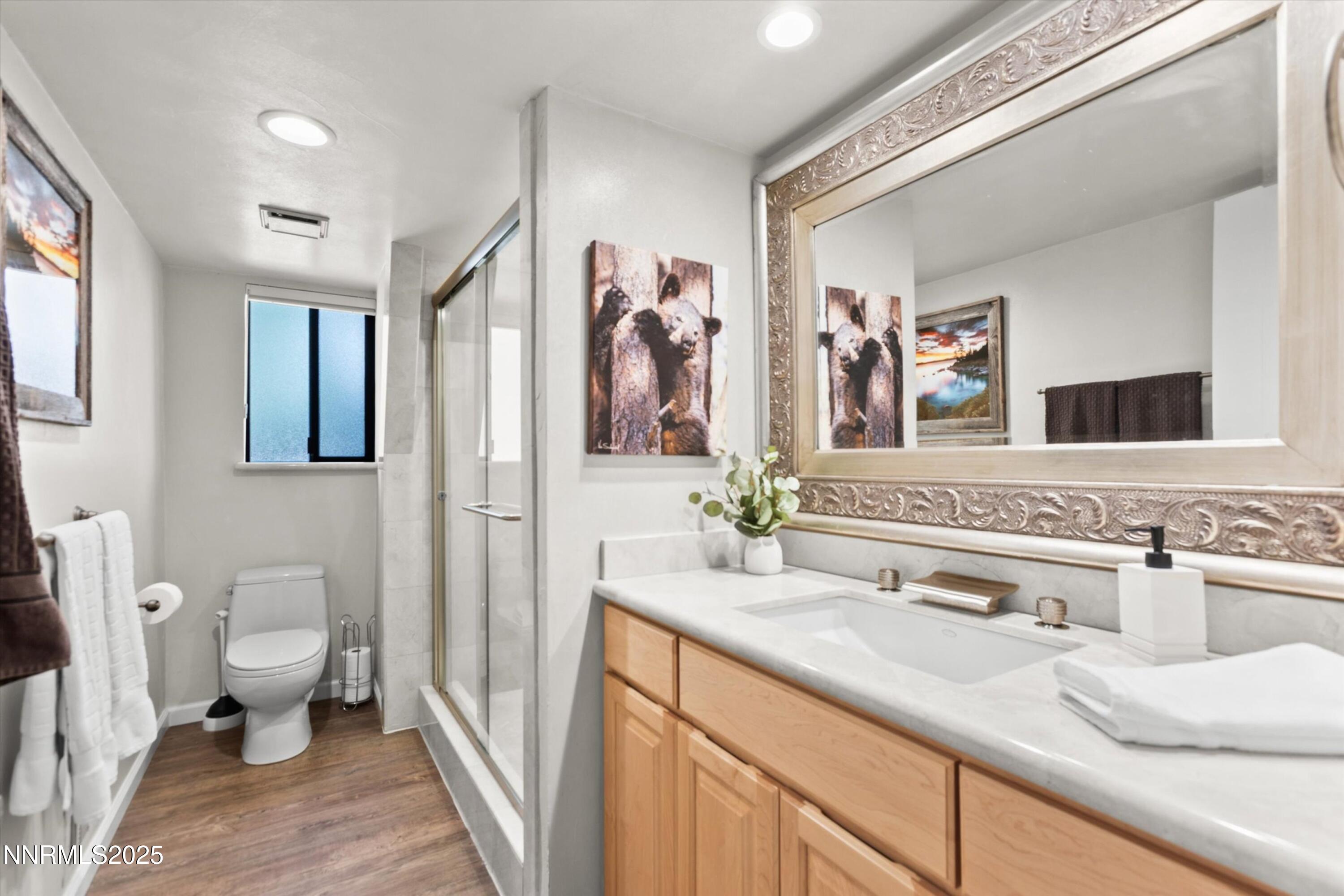 456 Jill Court Incline Village, NV 89451 - Photo 31 of 38 a bathroom with a granite countertop sink mirror vanity and toilet