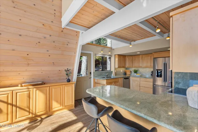 a kitchen with stainless steel appliances granite countertop a sink and cabinets