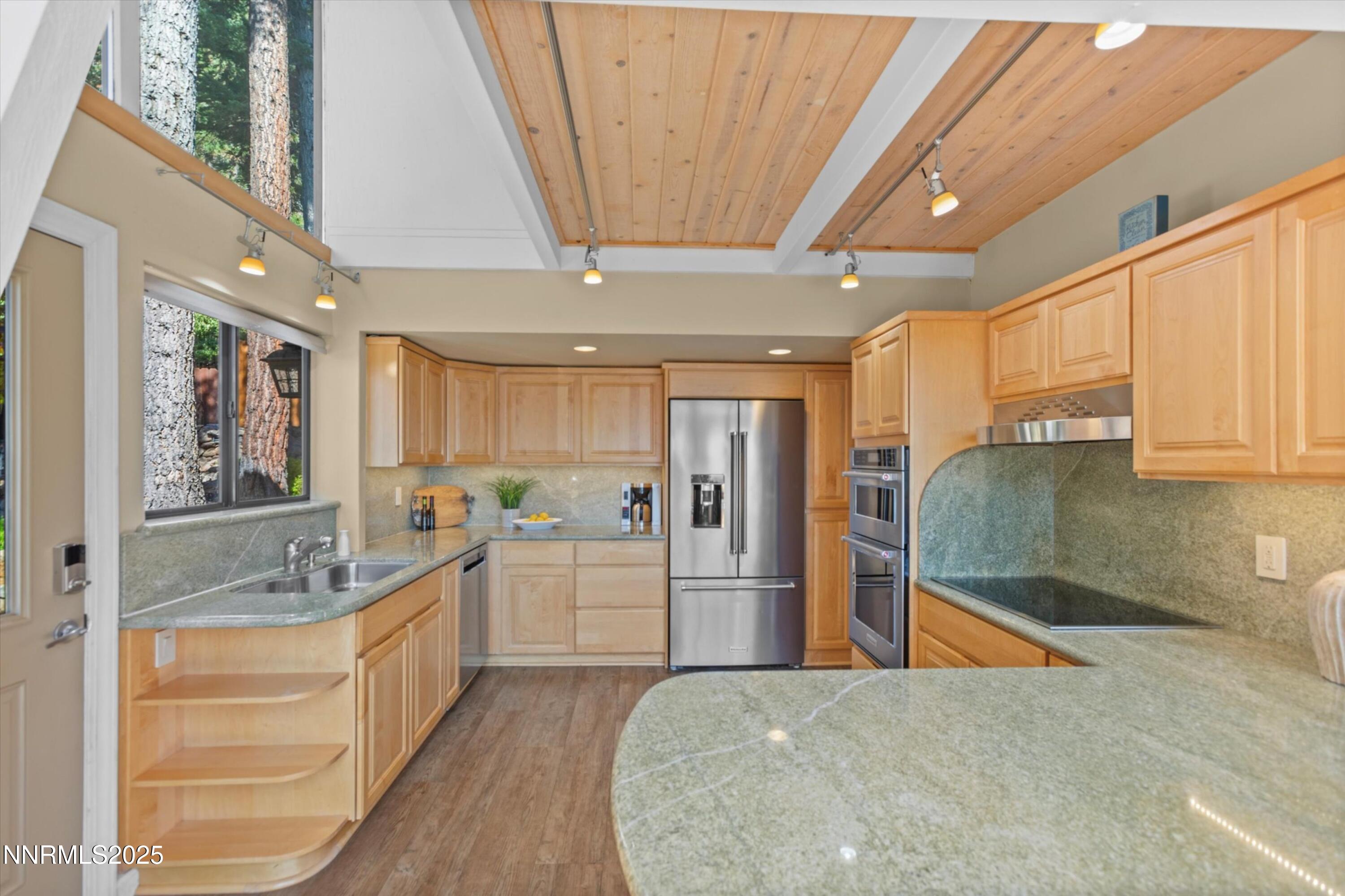 456 Jill Court Incline Village, NV 89451 - Photo 8 of 38 a large kitchen with stainless steel appliances kitchen island granite countertop a refrigerator and a sink