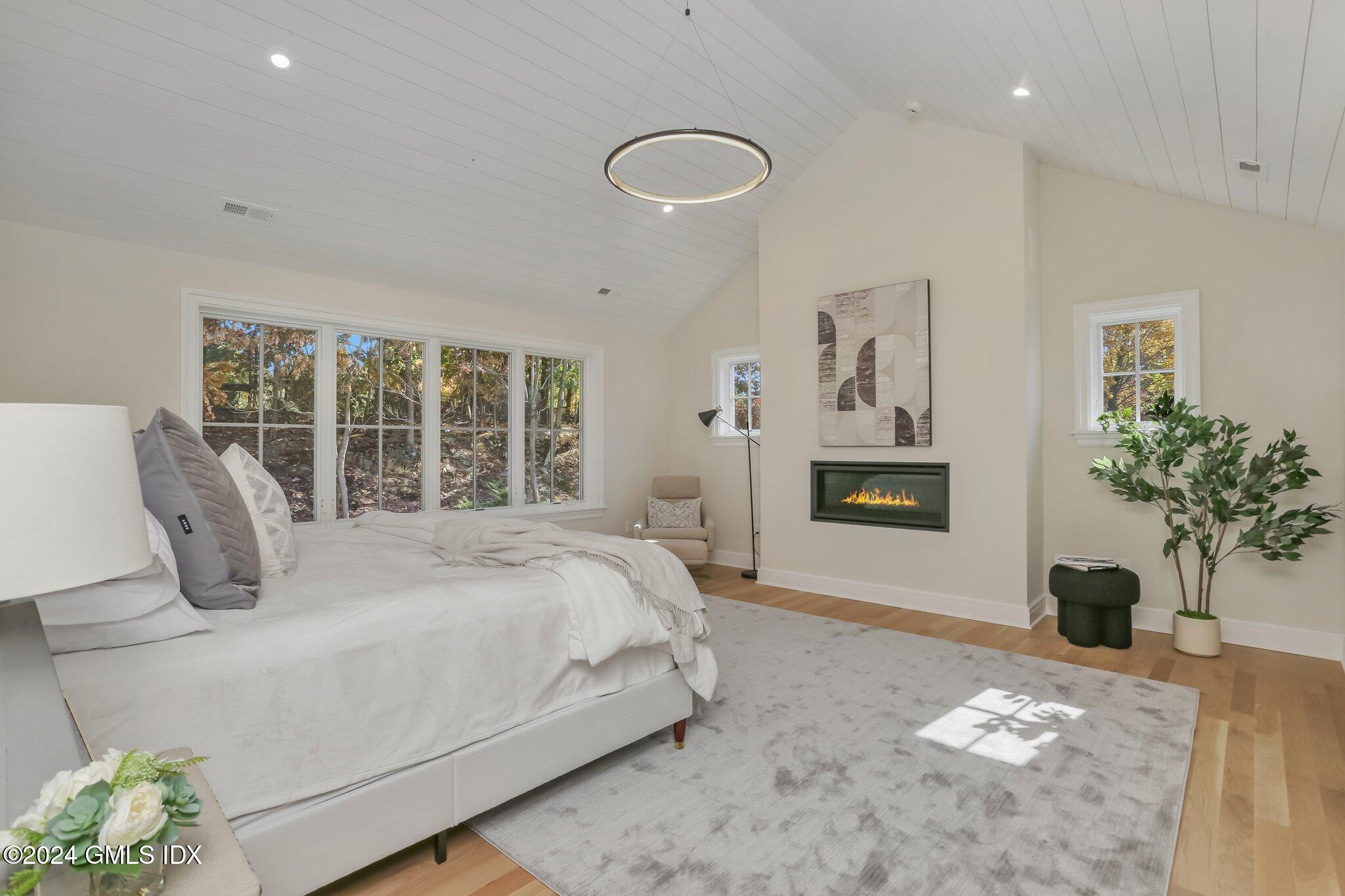 86 Mary Lane Riverside, CT 06878 - Photo 13 of 28 a bedroom with a large bed and a potted plant