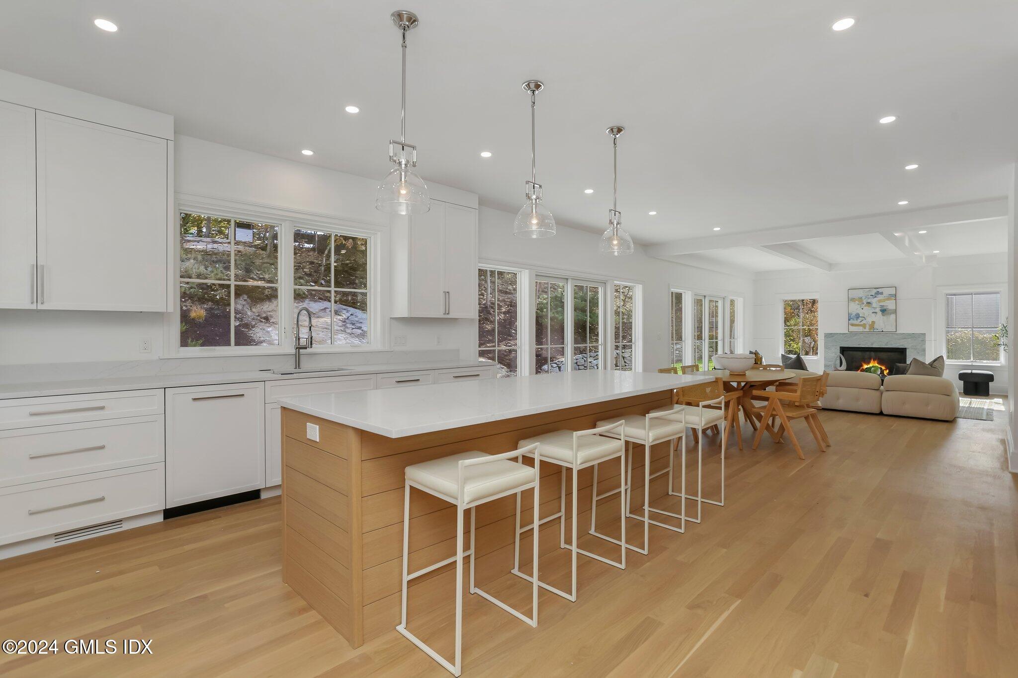 86 Mary Lane Riverside, CT 06878 - Photo 7 of 28 a large kitchen with a large counter top space a sink stainless steel appliances and cabinets