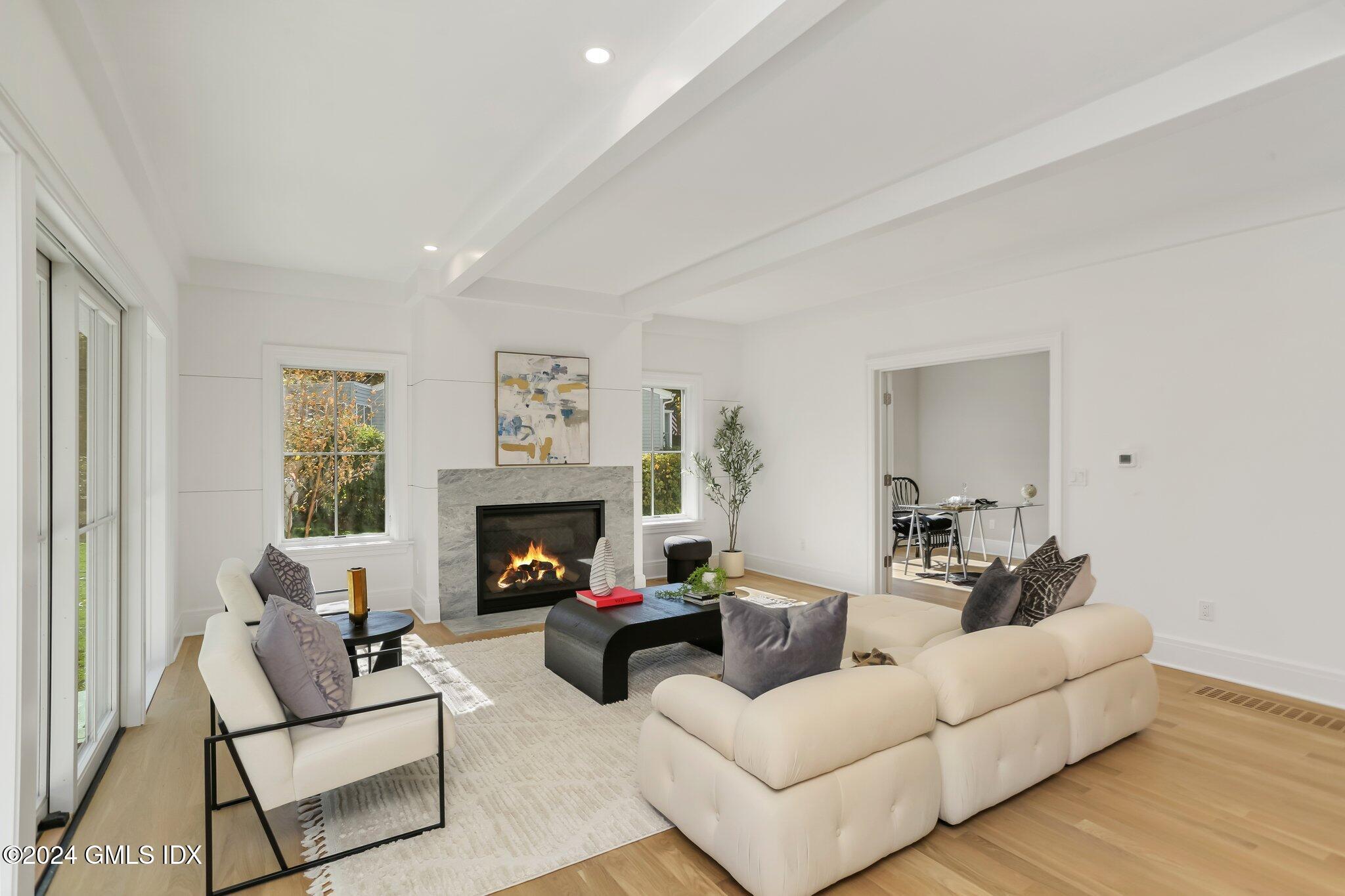 86 Mary Lane Riverside, CT 06878 - Photo 8 of 28 a living room with furniture a fireplace and a potted plant