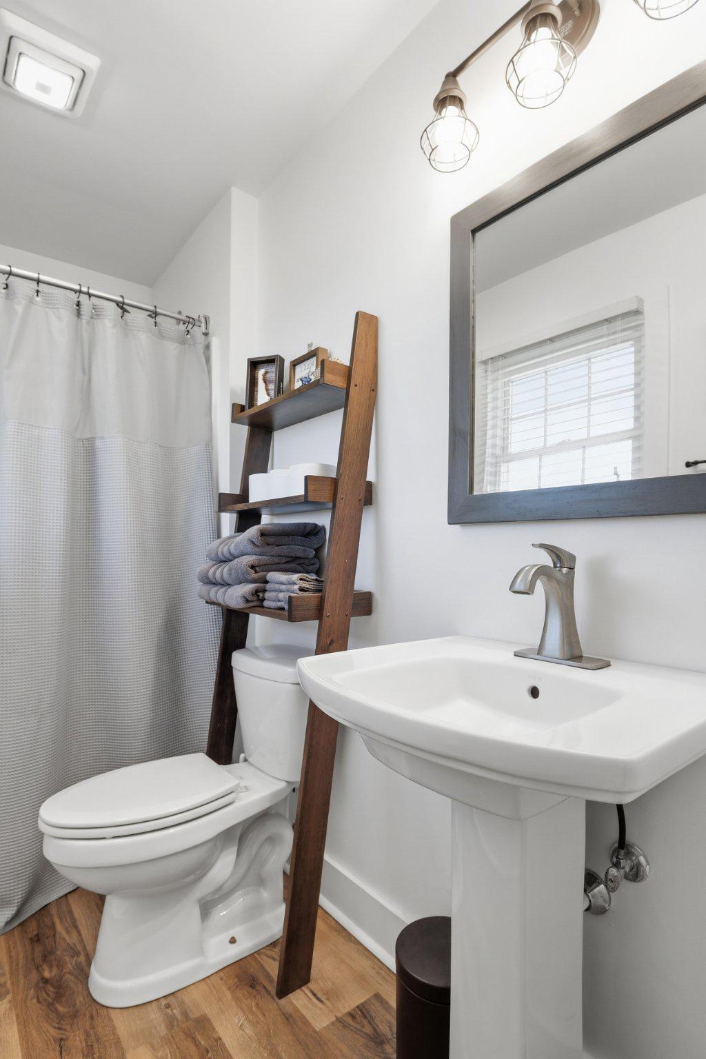 2246 Prospect Church Road Harrington, DE 19952 - Photo 19 of 47 a bathroom with a sink a toilet and shower curtain