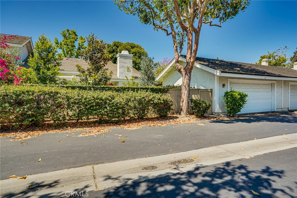 49 East Yale Loop, Unit 26 Irvine, CA 92604 - Photo 55 of 63 a front view of a house with a yard and garage