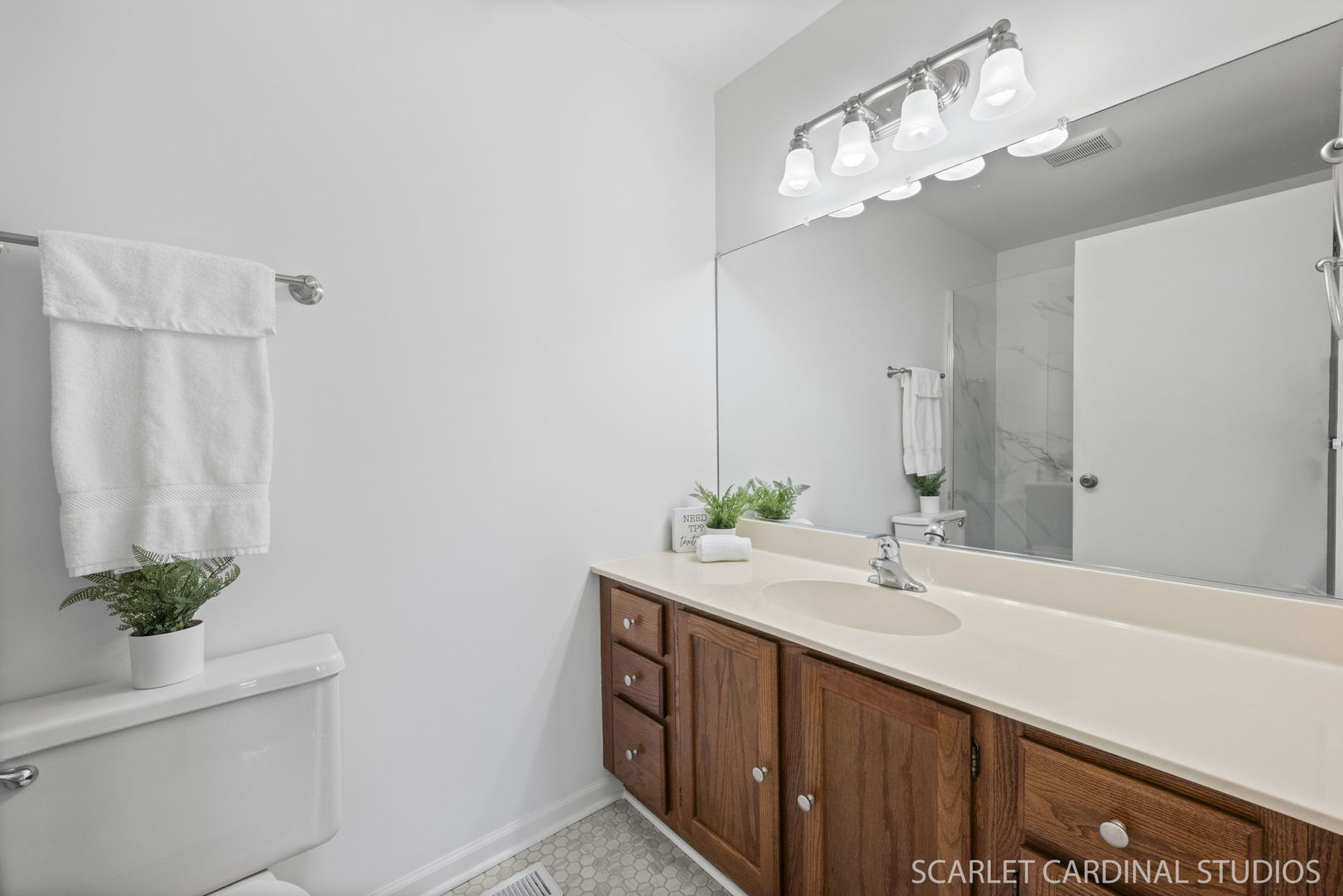 305 South Harrison Street, Unit 305 Geneva, IL 60134 - Photo 12 of 20 a bathroom with a double vanity sink and a mirror