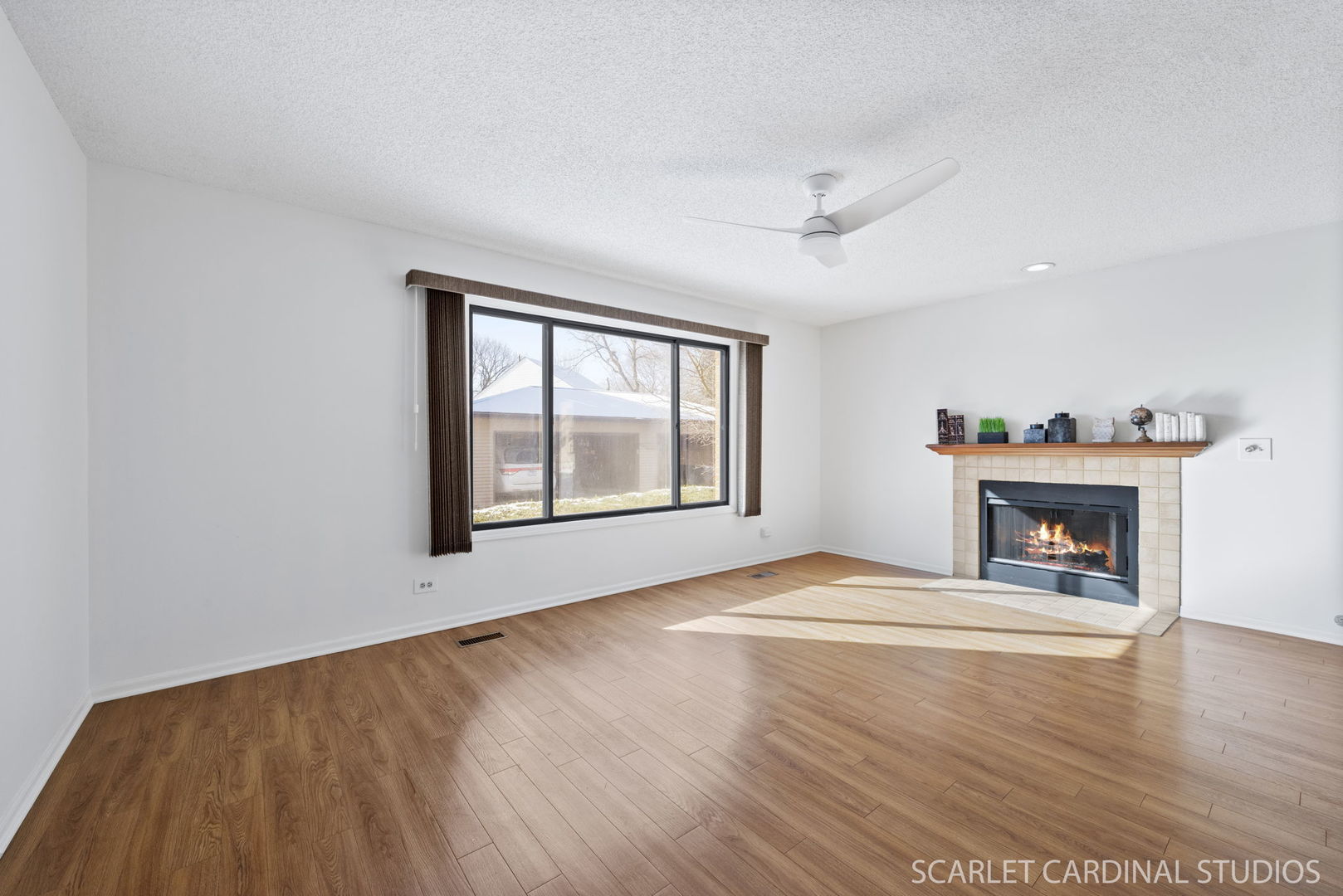 305 South Harrison Street, Unit 305 Geneva, IL 60134 - Photo 3 of 20 an empty room with windows fireplace and wooden floor