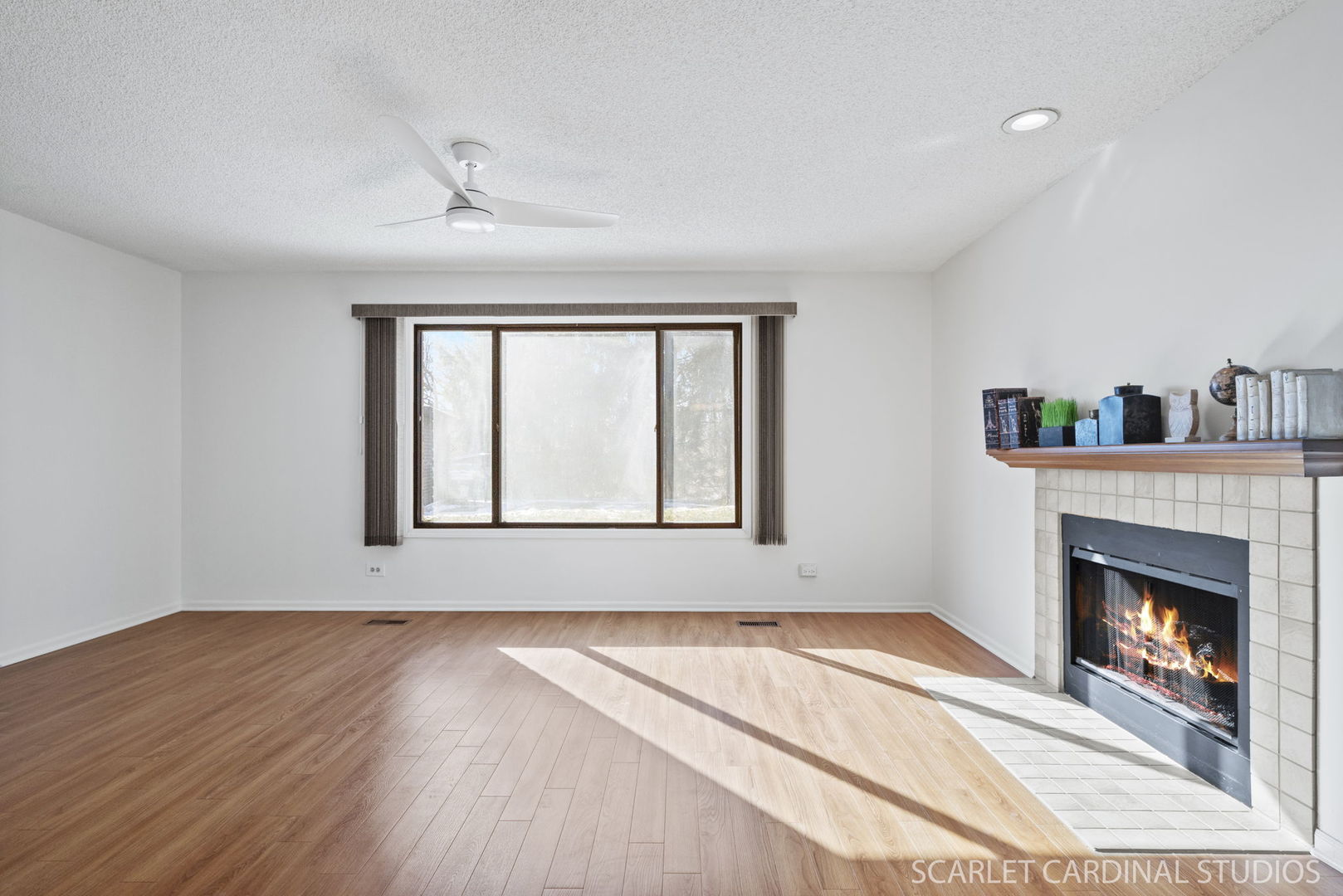 305 South Harrison Street, Unit 305 Geneva, IL 60134 - Photo 4 of 20 a view of an empty room with wooden floor fireplace and a window