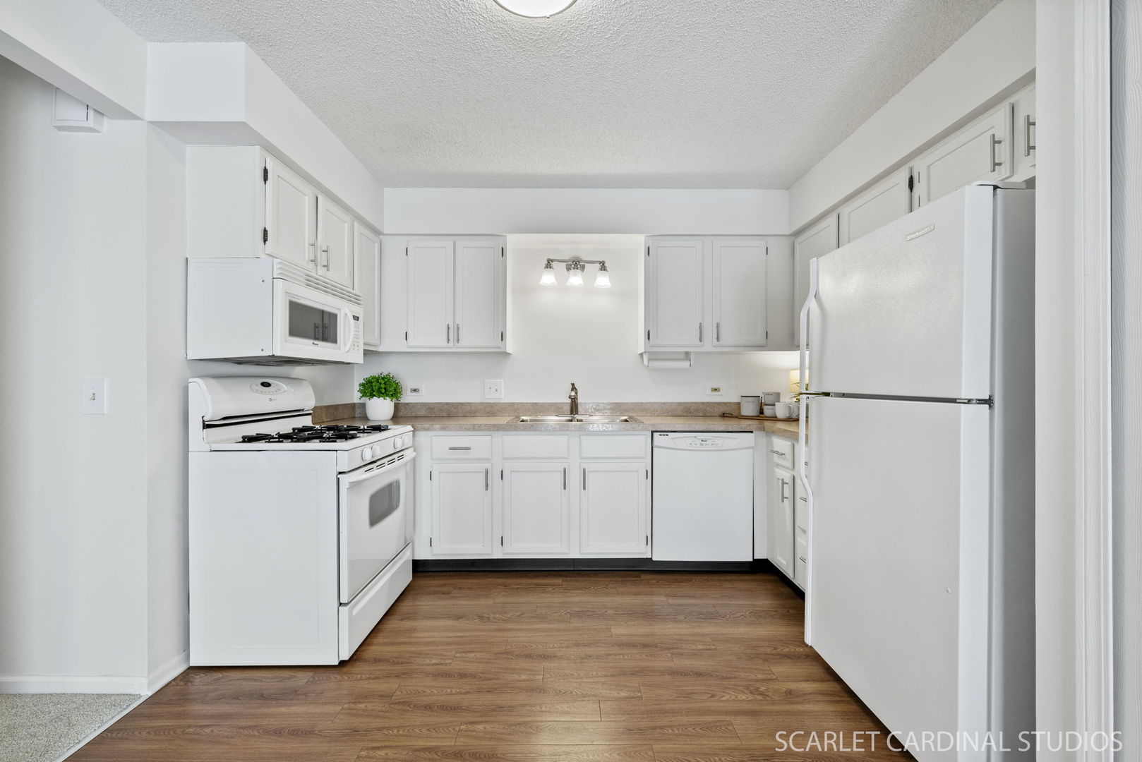 305 South Harrison Street, Unit 305 Geneva, IL 60134 - Photo 9 of 20 a kitchen with white cabinets and white appliances