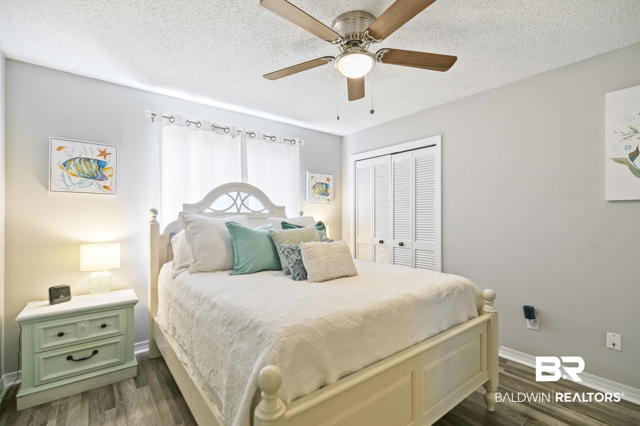 25957 Canal Road, Unit 302 Orange Beach, AL 36561 - Photo 11 of 26 Bedroom with a textured ceiling, a closet, ceiling fan, and dark hardwood / wood-style flooring