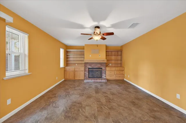 a bathroom with a granite countertop toilet sink and mirror