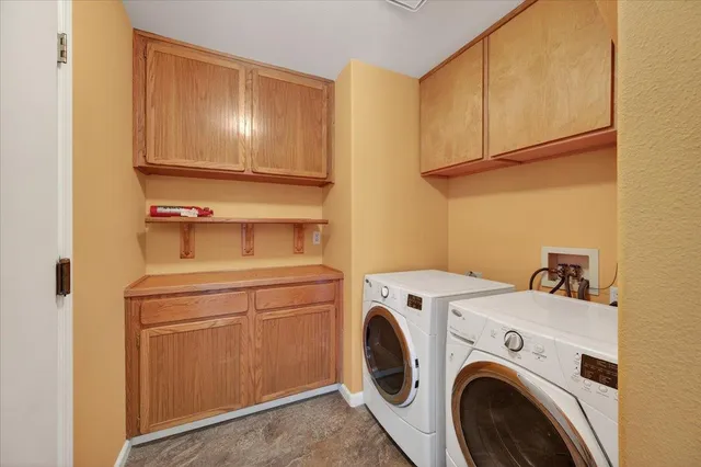 a view of a backyard with wooden fence and a large tree