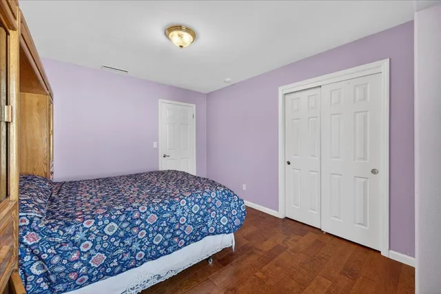 a view of a patio with table and chairs potted plants and large tree