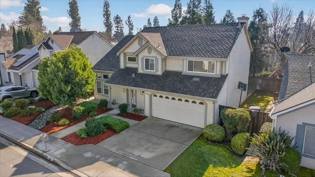 a aerial view of a house with a yard and potted plants