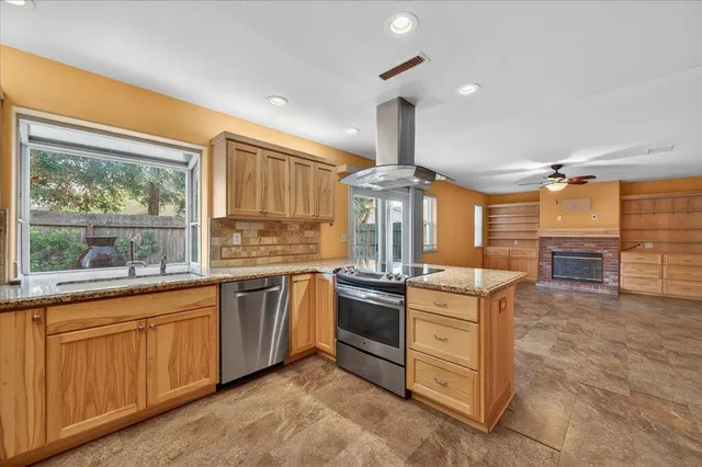 a kitchen with stainless steel appliances granite countertop a stove and a sink