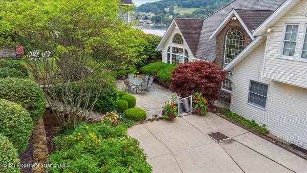 a view of a house with a yard and sitting area