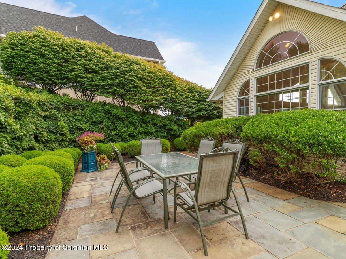 218 Point Road Lake Winola, PA 18419 - Photo 27 of 65 a view of a chairs and table in a backyard