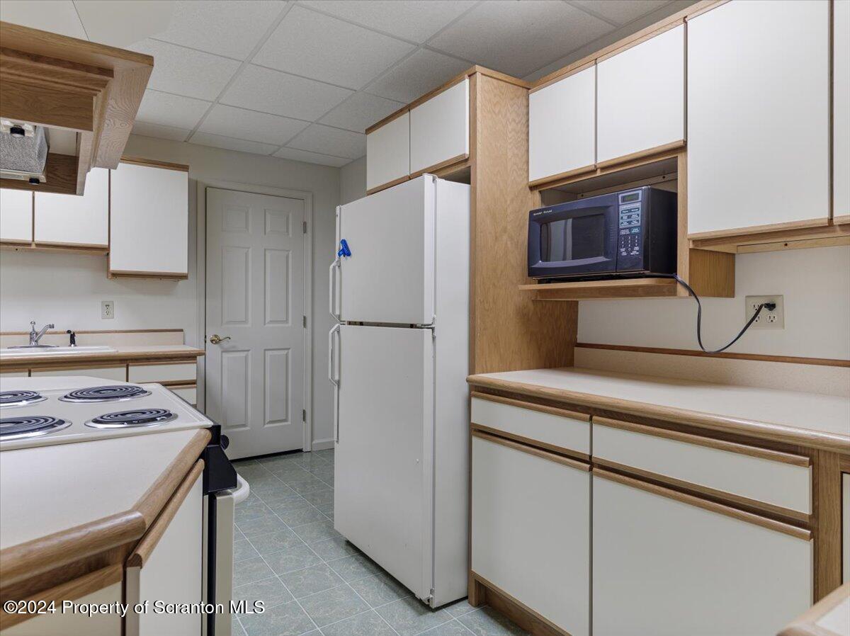 218 Point Road Lake Winola, PA 18419 - Photo 28 of 65 a kitchen with a refrigerator stove and microwave