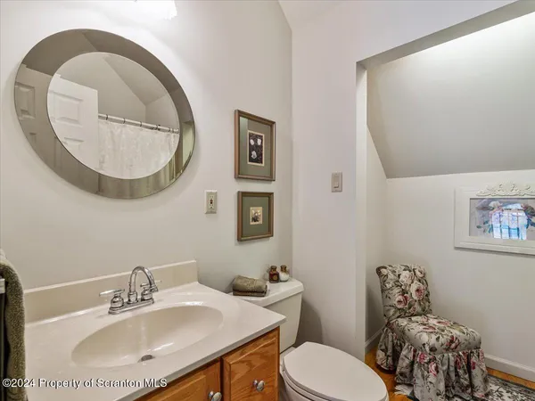 a bathroom with a tub a sink and a window