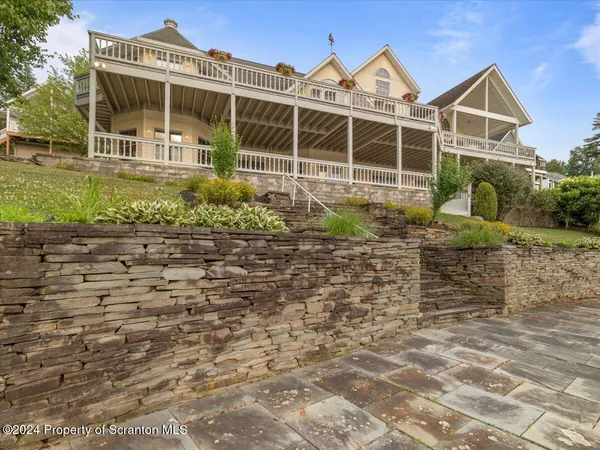 a view of a house with a yard and sitting area