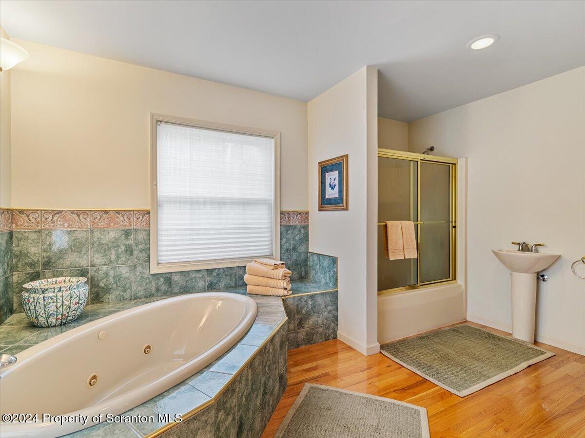 218 Point Road Lake Winola, PA 18419 - Photo 58 of 65 a bathroom with a tub a sink and a window