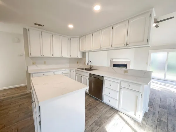a kitchen with white cabinets and white appliances
