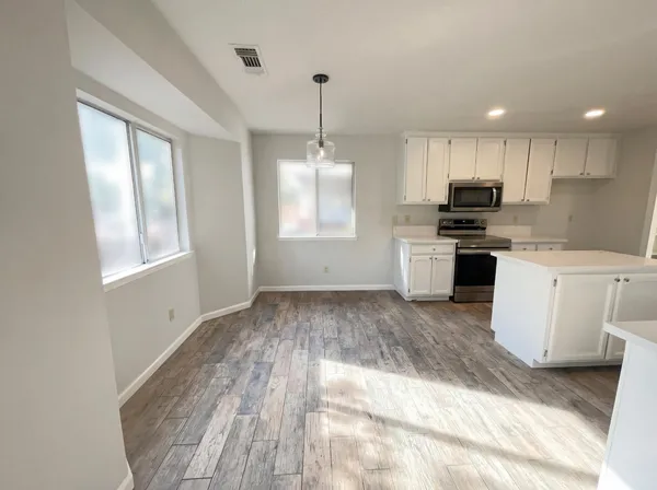 a kitchen with a stove a sink and a refrigerator